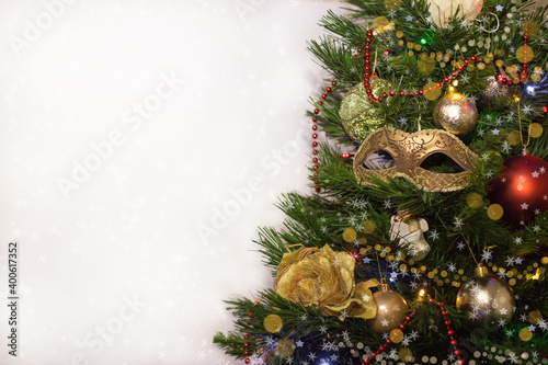 Decorated Christmas tree with masquerade mask on white background. space for text