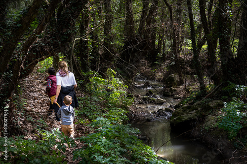 Mother with sons walking in forest