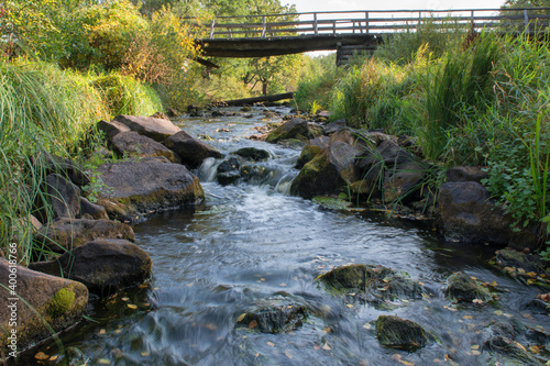 Wooden bridge over the river in summer day