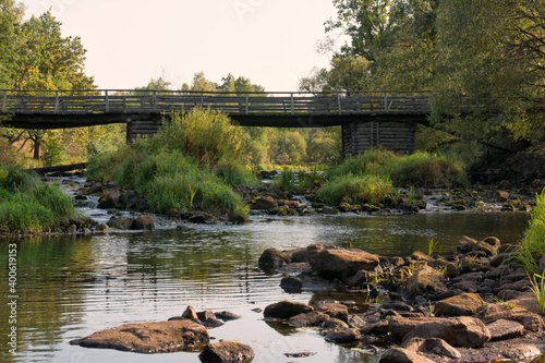 Wooden bridge over the river in summer day