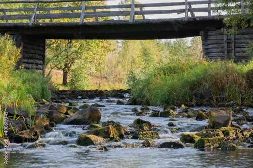 Wooden bridge over the river in summer day