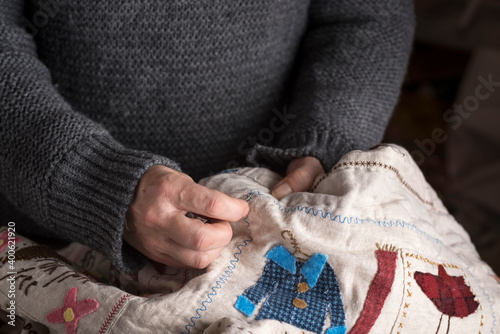 Closeup of female hands sewing a cloth