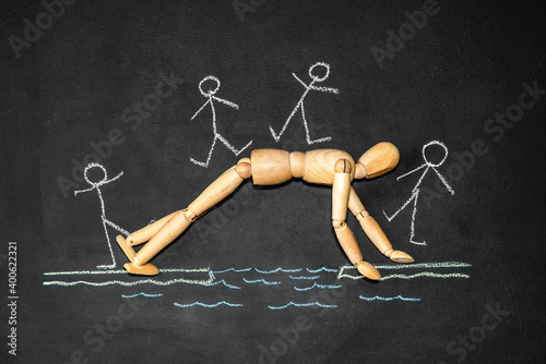 Fotografia Wooden man next to the inscription Altruism on a chalk board