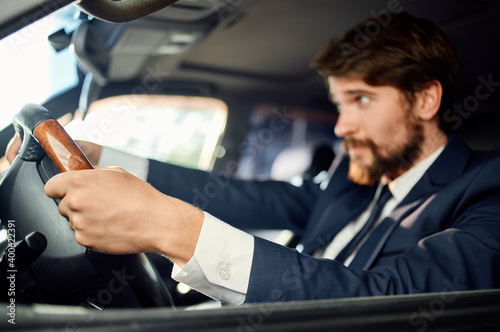 bearded man sitting in car salon in suit success trip lifestyle © SHOTPRIME STUDIO