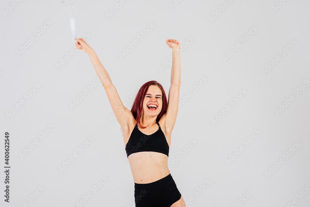 Female dancer in the styles of strip-plastic and pole dance with face mask on light background. Female dancer in the styles of strip-plastic and pole dance with face mask on light background.
