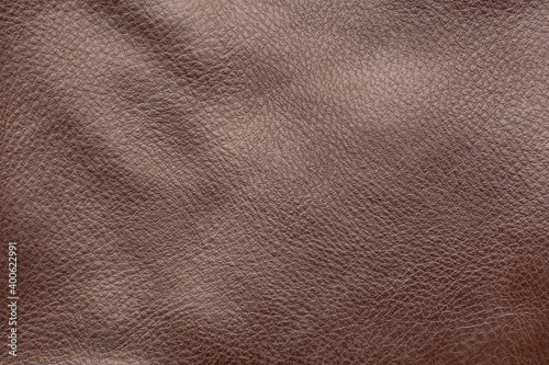 Brown smooth leather surface. Close-up. Texture background