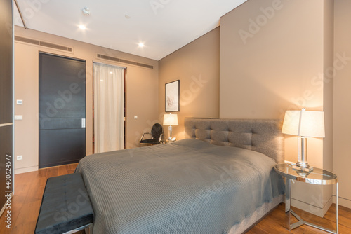 Bright  bedroom with king-size  bed with bedside tables and lamps © alhim