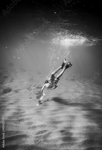Young boy swimming underwater