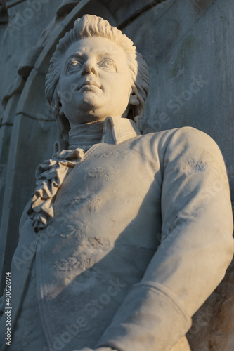 Stone figure of musical genius, composer Wolfgang Amadeus Mozart, in a monument from 1898, Vertical view © Dante