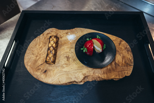Red Foie Gras served on  wooden slab background, with black tray. Xmas, celebration, luxury expensive food