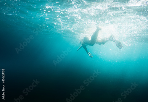 Fototapeta Naklejka Na Ścianę i Meble -  Person diving underwater