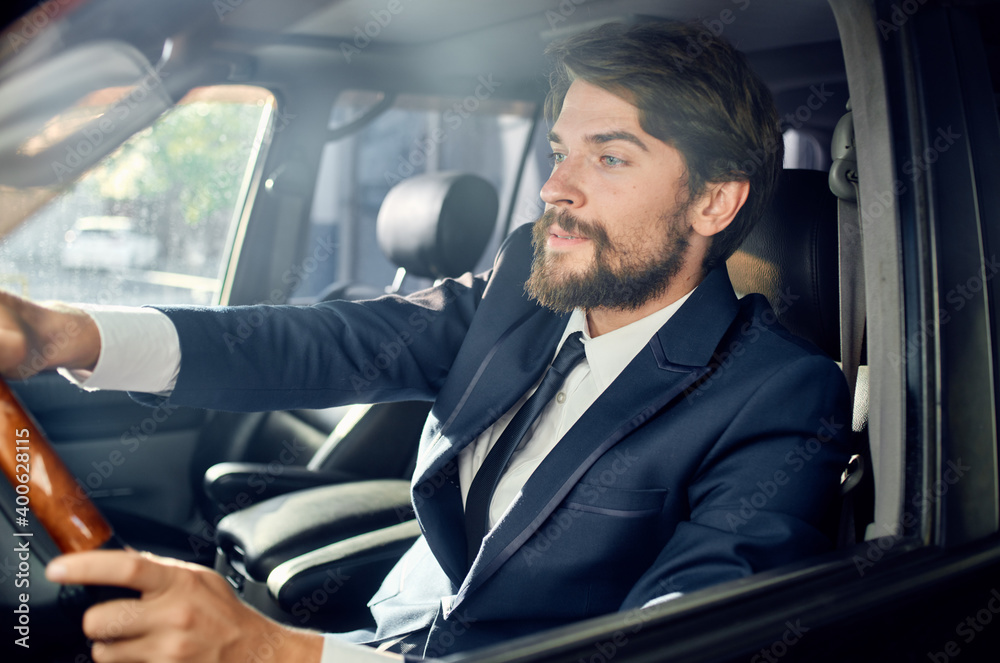 business man in a suit driving a car trip road passenger