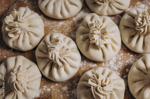 National Georgian cuisine. Khinkali with meat. Khinkali on a wooden background. Preparation process photo