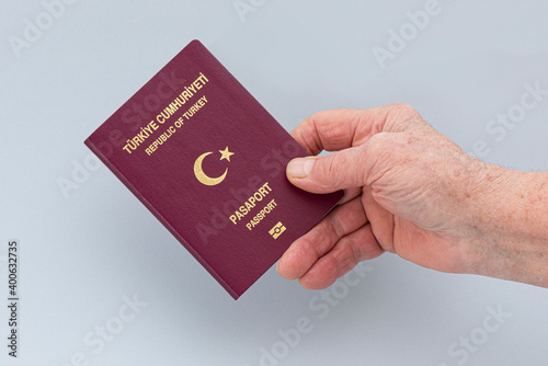 Turkish citizen public passport on th gray background.