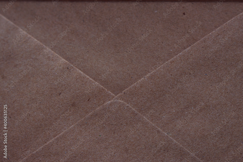 Fototapeta premium opened envelope which is made from recycled paper - close up, textured paper background, message and letter