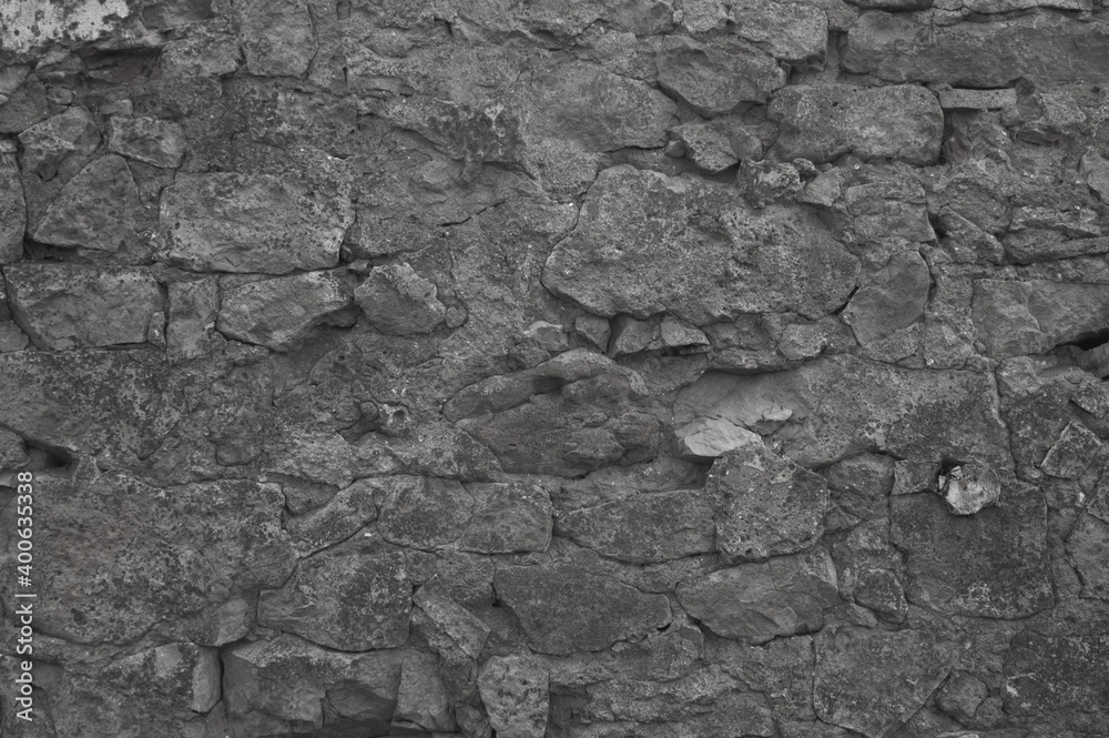 gray background. in the photo, the stone wall of the old building gray background. in the photo, the stone wall of the old building