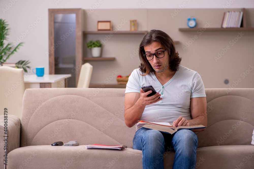 Young male student preparing for exams at home Young male student preparing for exams at home