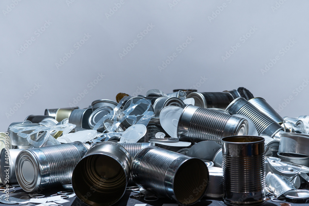 Metal tins, cans and jar garbage from household on the table. City home