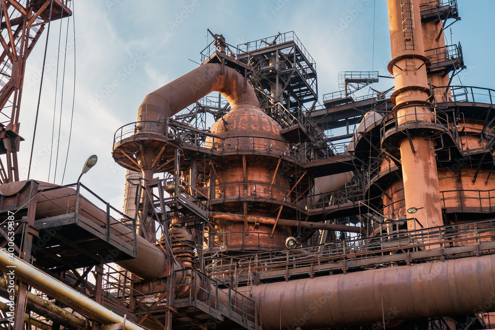 Metallurgical plant blast furnace and smokestacks. Industrial iron background