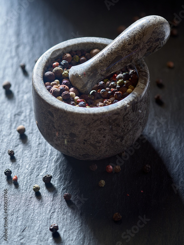 Stone Mortar and pestle with pepper seeds Fototapet