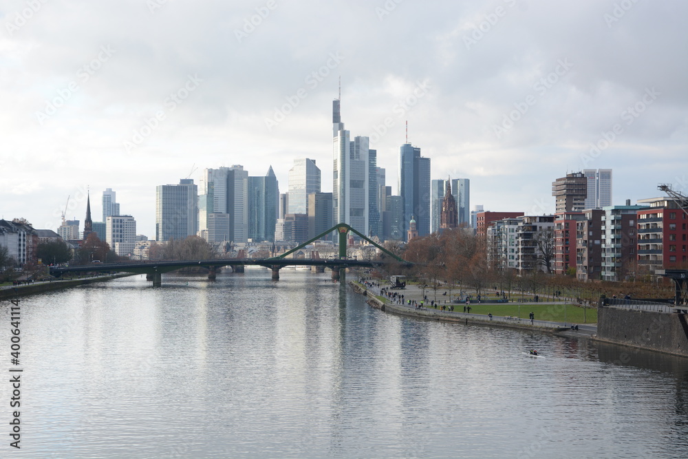 Fototapeta premium View on Frankfurts Skyline, seen from a bridge over the river Main