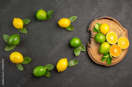 top view fresh sour lemons on dark-grey desk lime tree fruit citrus