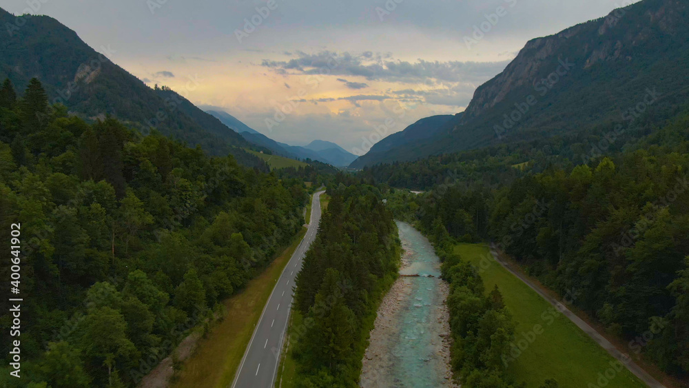 DRONE: Flying above a scenic road leading towards the town of Kranjska Gora.