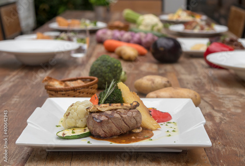 Chargrilled beef tenderloin with mixed vegetables, potato gratin mushroom sauce
