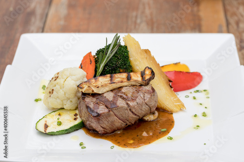 Chargrilled beef tenderloin with mixed vegetables, potato gratin and mushroom sauce