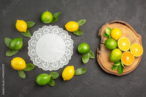 top view fresh sour lemons on the dark-grey background lime tree fruit citrus