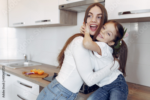 Beautiful woman with child. Woman in a white blouse. Mother's day. © prostooleh