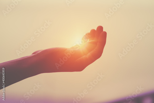 Fototapeta light, sun in human hand, spirituality and energy concept, praying hands