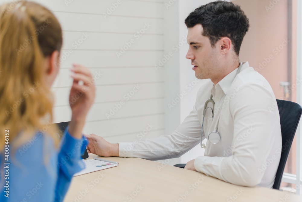 Fototapeta premium Doctors are explaining and analyzing the patient's illness. The doctor put a stethoscope on his neck.
