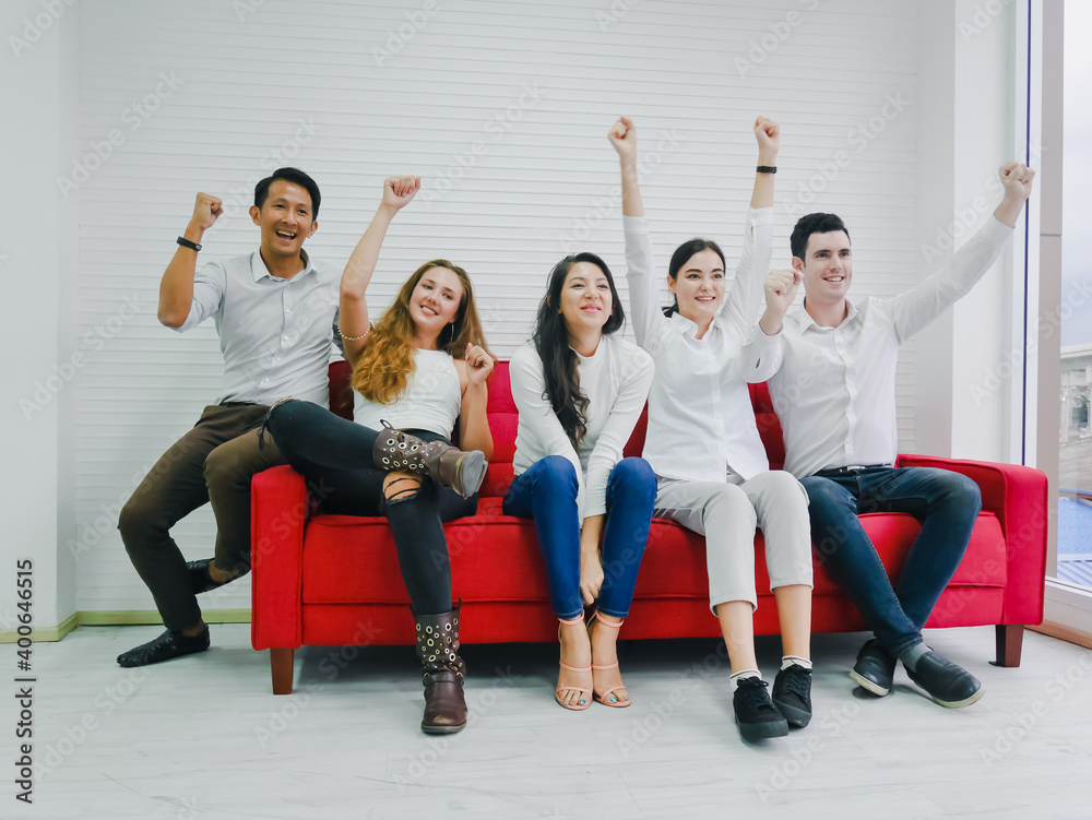 Friends cheering on sports from the television in the room, the mood of the winning supporters, everyone was happy Friends cheering on sports from the television in the room, the mood of the winning supporters, everyone was happy