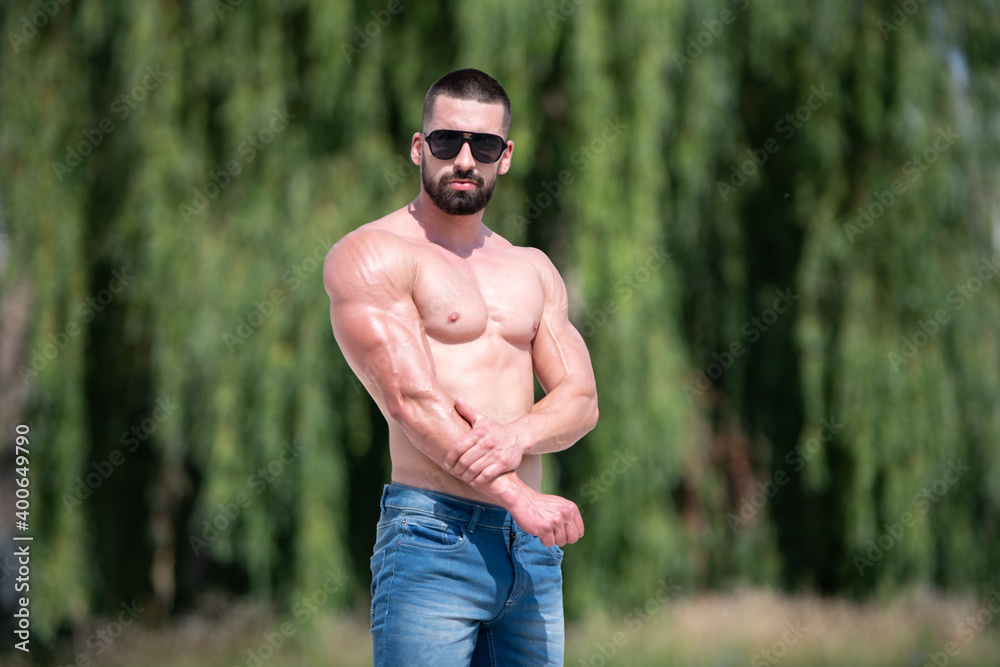 Portrait of Muscular Man Standing Strong Outdoors Portrait of Muscular Man Standing Strong Outdoors