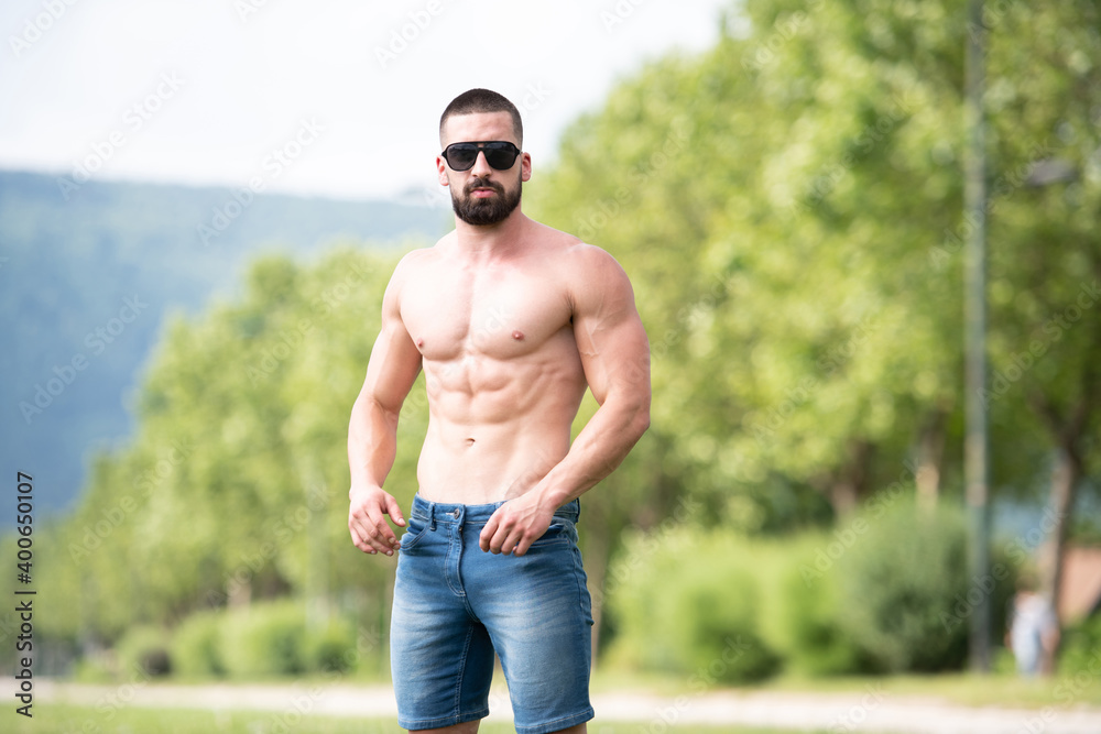 Portrait of Muscular Man Standing Strong Outdoors Portrait of Muscular Man Standing Strong Outdoors