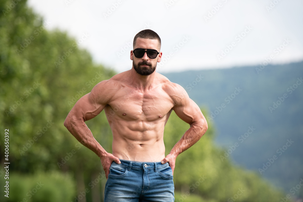 Portrait of Muscular Man Standing Strong Outdoors Portrait of Muscular Man Standing Strong Outdoors