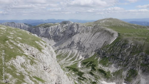 Aerial - Slowly revealing a insanely big crater in the Austrian alps. On the bottom right hand side you can see a little chamois for size difference photo