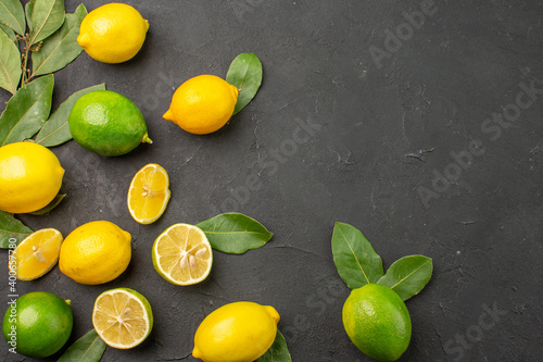 Fototapeta Naklejka Na Ścianę i Meble -  top view fresh lemons sour fruits on a dark background tree citrus lime fruit