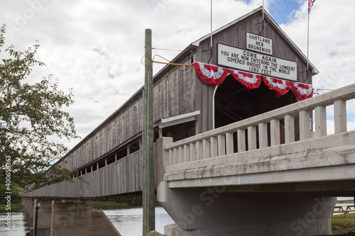 NEW  BRUNSWICK, CANADA - August 6, 2017: Entrance of of Hartland covered  bridge in New Brunswick. This 390-m (1,282-ft.) bridge opened on 1901, the longest wooden covered bridge in the world.  photo