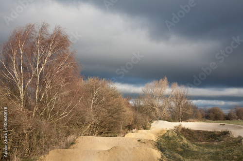 Empty mountain bike track with rollers and berm in winter.