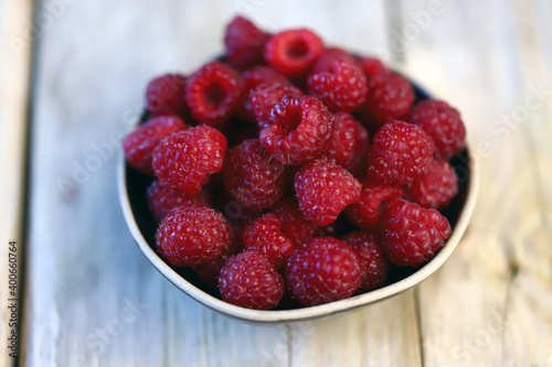 Fresh juicy raspberries in a bowl. Dessert berry raspberry.