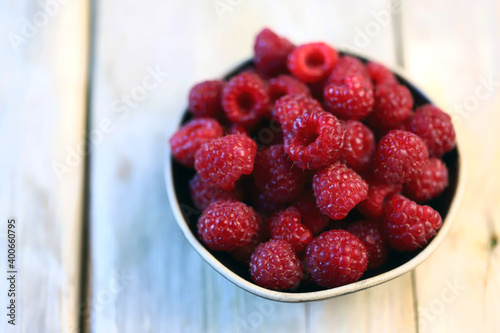 Fresh juicy raspberries in a bowl. Dessert berry raspberry.