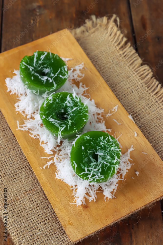 Kue Lumpang Pandan, kue ijo or kuih lompang. Traditional rice flour, tapioca and pandanus steamed cupcake from Indonesia Kue Lumpang Pandan, kue ijo or kuih lompang. Traditional rice flour, tapioca and pandanus steamed cupcake from Indonesia