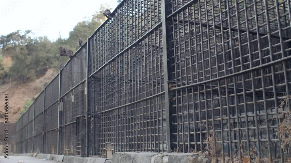A line of old abandoned wrought iron caged in the old zoo of griffith park in los angeles A line of old abandoned wrought iron caged in the old zoo of griffith park in los angeles
