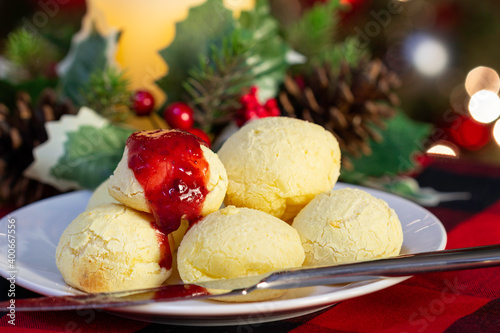 Cheese bread (Pão de Queijo) traditional Brazilian food to eat with coffee, minas gerais, with strawberry jam, wooden table, christmas, new year, mineiro,