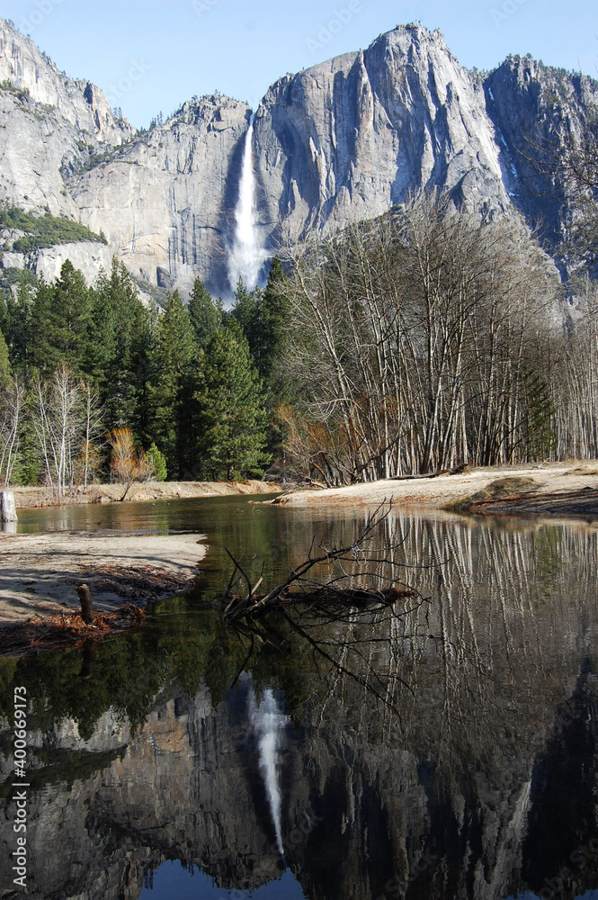 Yosemite waterfall with reflection on the river and trees