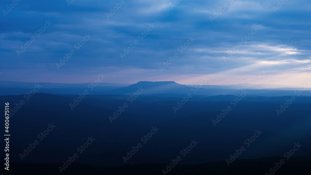 Fototapeta premium dramatic sunset sunset sky wide and high mountain landscape Pha Yieb Mek in Phu Kradueng National park. Thailand