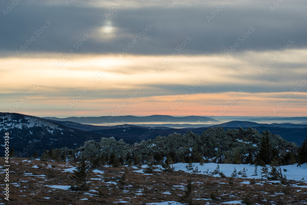 mountain tundra with rare trees and rocks in the sunset rays mountain tundra with rare trees and rocks in the sunset rays