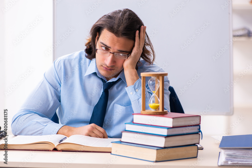 Young businessman student in time management concept Young businessman student in time management concept
